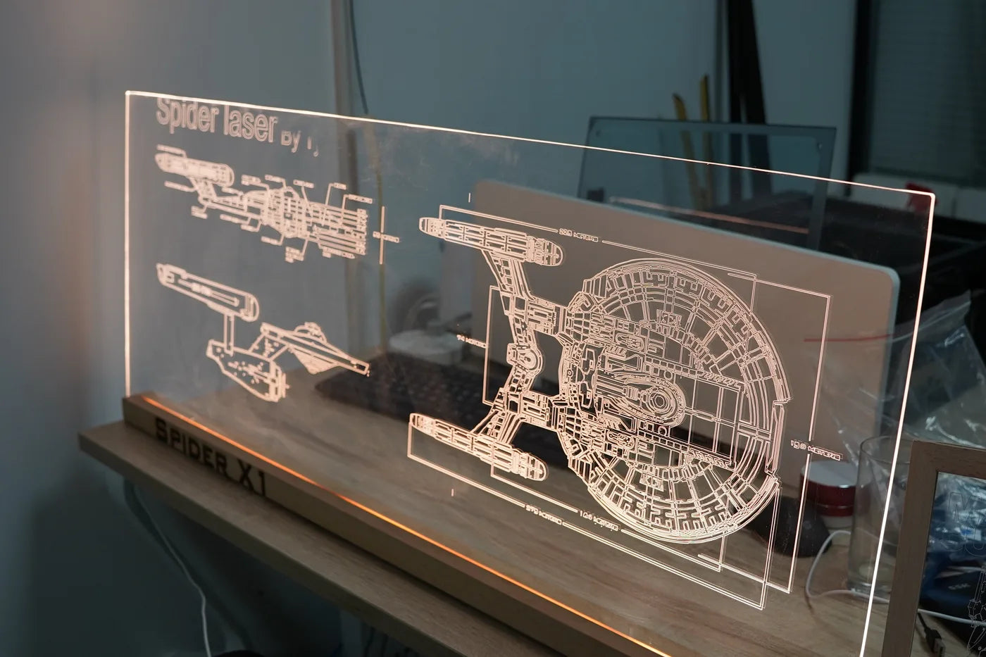 Edge-lit engraved acrylic display shown as a TYVOK X1S project reference